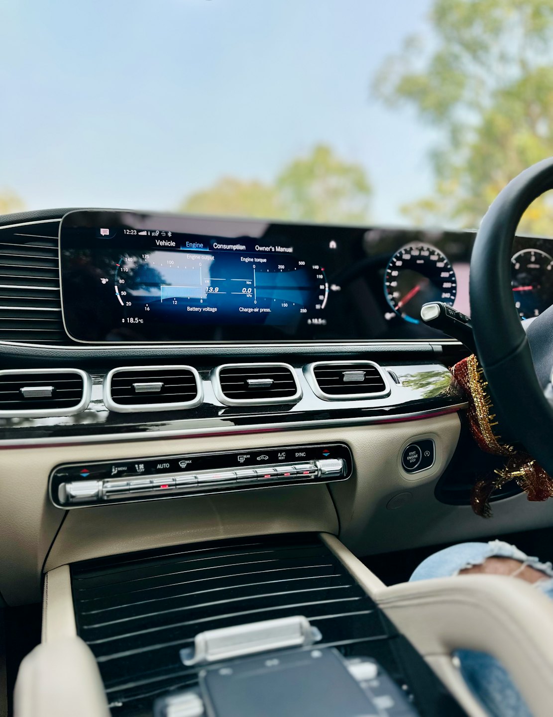 Modern car dashboard with digital display and controls.